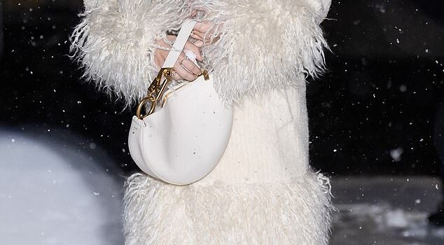 Sydney Sweeney the snow queen models stylish ivory coat as she playfully chucks snowballs in frigid NYC